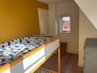 a bedroom with a bed and a window at Luxurious sunny beach villa in Noordwijk