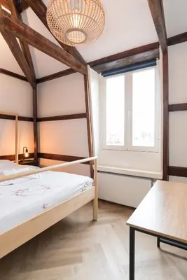a bedroom with a bed and a large window at Prinsen Terrace - Boutique apartment in the Centre in Amsterdam
