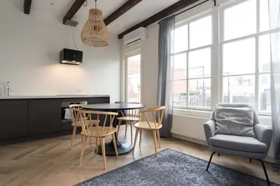 a kitchen and dining room with a table and chairs at Prinsen Terrace - Boutique apartment in the Centre in Amsterdam