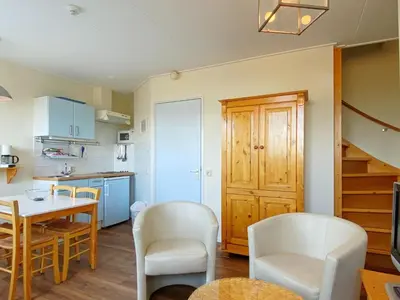 a kitchen and dining room with a table and chairs at Stay in Bergen aan Zee in Bergen aan Zee