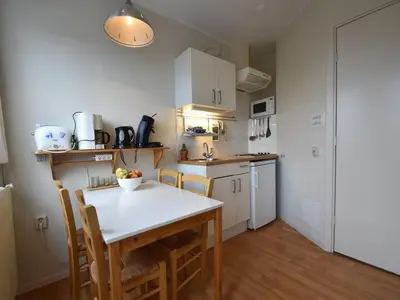 a kitchen with a table and chairs in a room at Stay in Bergen aan Zee in Bergen aan Zee