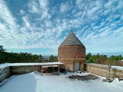 a brick tower with a table on a snow covered roof at Apartment in Bergen aan Zee near Beach in Bergen aan Zee