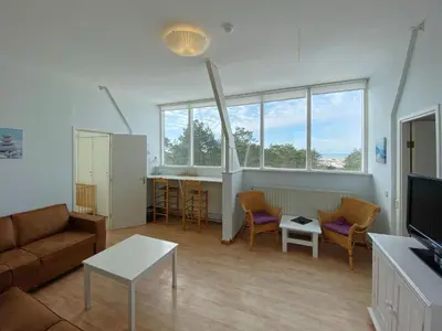 a living room with a couch and a table at Apartment in Bergen aan Zee near Beach in Bergen aan Zee
