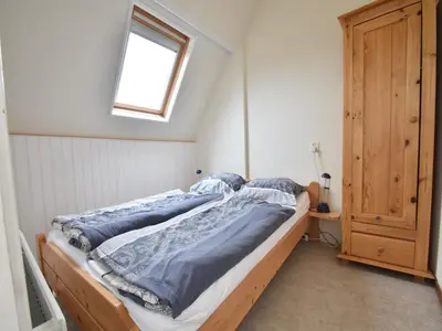a bed in a room with a window at Apartment in Bergen aan Zee near Beach in Bergen aan Zee