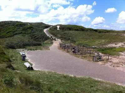 a winding road with bikes on the side of a hill at Dune Top Family Retreat in Bergen aan Zee