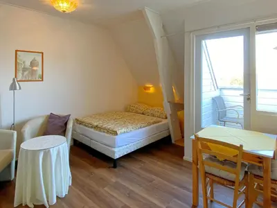 a small room with a bed and a table at Apartment in Bergen near the Beach in Bergen aan Zee