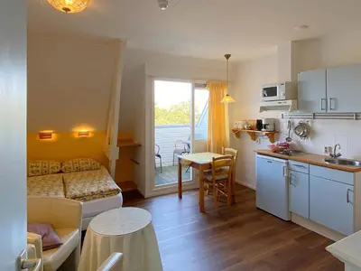 a small apartment with a kitchen and a living room at Apartment in Bergen near the Beach in Bergen aan Zee