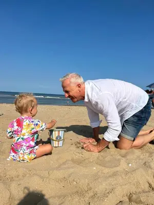 a man playing with a little girl on the beach at Beautiful loft in Katwijk aan Zee in Katwijk aan Zee