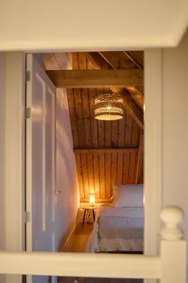a bedroom with a bed and a chandelier in a room at Appartement B Rosita in Twisk