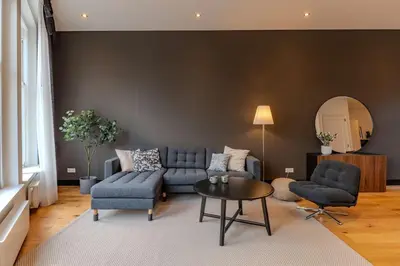 a living room with a blue couch and a table at Haarlem Hart in Haarlem