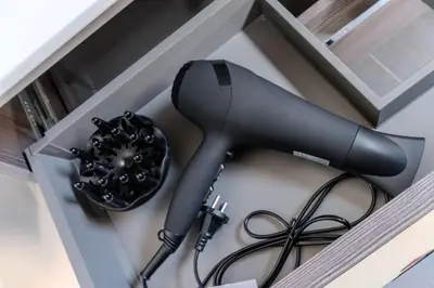 a black hair dryer sitting in a drawer at Haarlem Hart in Haarlem