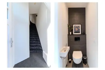 a bathroom with a sink and a staircase at Haarlem Hart in Haarlem