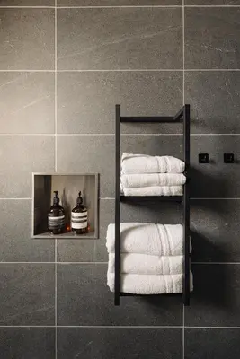 a group of towels on a towel rack in a bathroom at De Ooievaar in Naarden