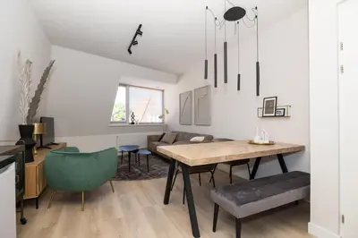 a kitchen and living room with a table and chairs at Hoorn Center - Dashing Hoorn in Hoorn