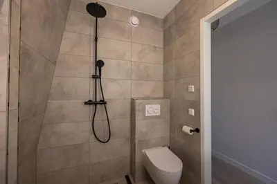 a bathroom with a shower with a toilet at Hoorn Center - Dashing Hoorn in Hoorn