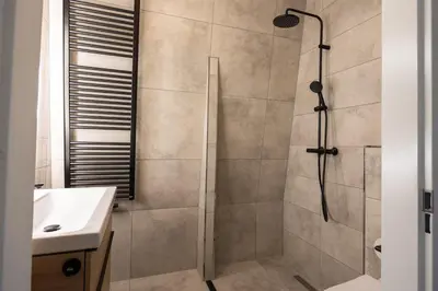 a bathroom with a shower and a sink at Hoorn Center - Dashing Hoorn in Hoorn