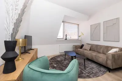 a living room with a couch and a chair at Hoorn Center - Dashing Hoorn in Hoorn