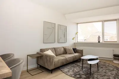 a living room with a couch and a table at Hoorn Centre - Catching Hoorn in Hoorn