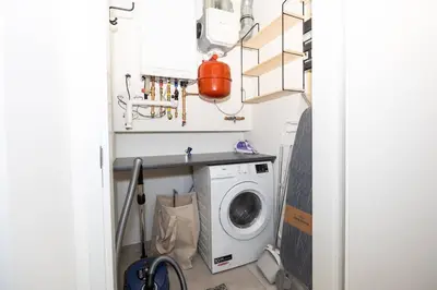a laundry room with a washer and a washing machine at Hoorn Centre - Catching Hoorn in Hoorn