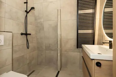 a bathroom with a shower and a toilet and a sink at Hoorn Centre - Catching Hoorn in Hoorn