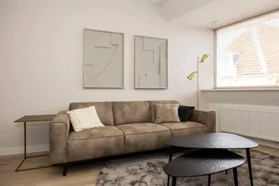 a living room with a couch and a table at Hoorn Centre - Catching Hoorn in Hoorn