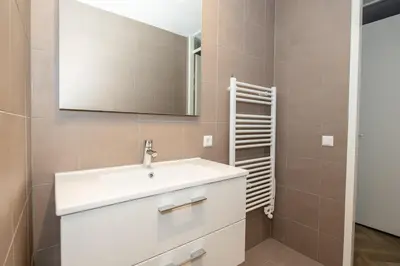a bathroom with a white sink and a mirror at Serviced Accommodation Hoorn - Corporate Housing NN38 in Hoorn