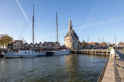 two boats are docked in a river with a castle at Serviced Accommodation Hoorn - Corporate Housing NN38 in Hoorn