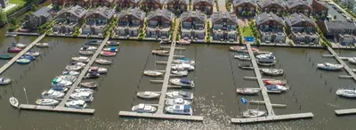 a group of boats are docked in a harbor at Houseboat Uitgeest in Uitgeest