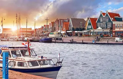 a boat is docked at a dock in a harbor at Houseboat Uitgeest in Uitgeest