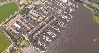 an aerial view of a parking lot next to the water at Houseboat Woude Uitgeest in Uitgeest