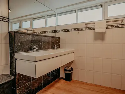 a bathroom with a sink and a mirror at Houseboat Woude Uitgeest in Uitgeest