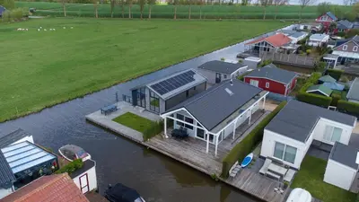 an aerial view of a house on a dock in the water at Wilgenroos 6P - Lijsterlaan 198 in Wervershoof