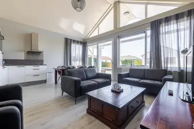 a living room with couches and a coffee table at Wilgenroos 6P - Lijsterlaan 198 in Wervershoof
