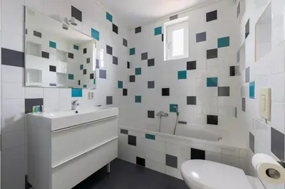 a bathroom with a sink and a tub and a toilet at Wilgenroos 6P - Lijsterlaan 198 in Wervershoof