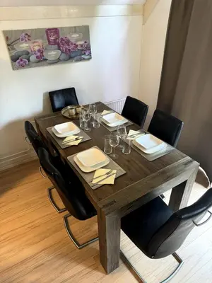 a dining room table with chairs and a wooden tableablish at 3 bedrooms Family House till 6 p Near Amsterdam & Sea in Opmeer