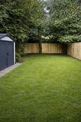 a backyard with a fence and a grass yard at 3 bedrooms Family House till 6 p Near Amsterdam & Sea in Opmeer