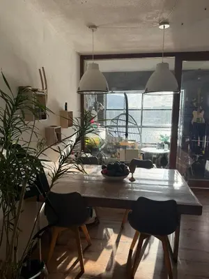 a dining room with a table and some plants at Near Amsterdam central station in Amsterdam