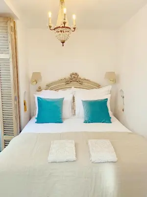 a bedroom with a large white bed with blue pillows at La Bastide in Heiloo