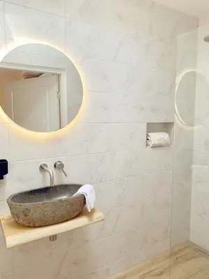 a bathroom with a sink and a mirror at La Bastide in Heiloo
