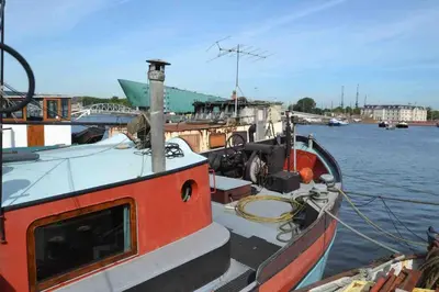 a boat is docked at a dock in the water at Marie's Houseboat in Amsterdam