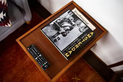 a book and a remote control sitting on a table at Marie's Houseboat in Amsterdam