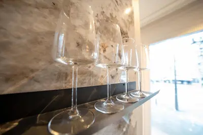 three empty wine glasses sitting on a shelf at B&B Blaauw - Raadhuis Suite in Heemstede