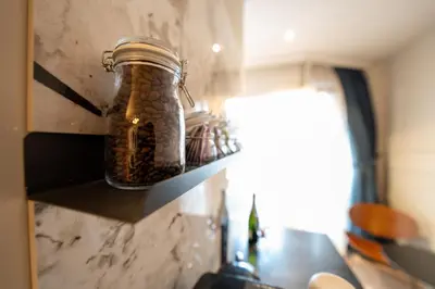 a jar of beans sitting on a shelf in a kitchen at B&B Blaauw - Raadhuis Suite in Heemstede