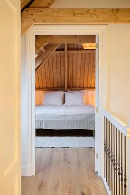 a bedroom with a white bed in a attic at Appartement C Rosita in Twisk