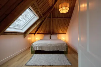 a bedroom with a large bed in a attic at Appartement C Rosita in Twisk