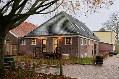 a brick house with a black roof at Appartement C Rosita in Twisk