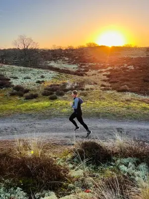 a man running in a field at sunset at Elements The Residence Luxe villa en guesthouse in Bergen