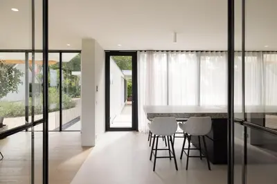 a kitchen with a table and chairs in a house at Elements The Residence Luxe villa en guesthouse in Bergen