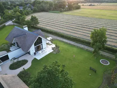 an aerial view of a house with a large field at Elements The Residence Luxe villa en guesthouse in Bergen