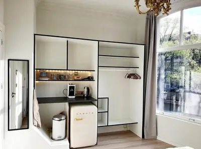a kitchen with a white refrigerator and a window at As Home in Amsterdam